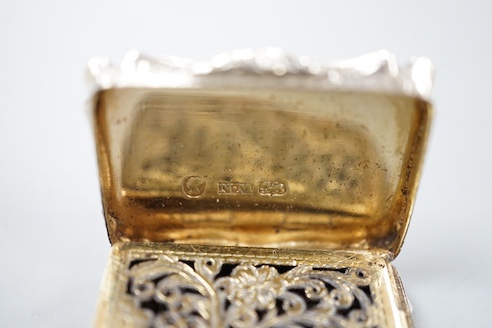 An early Victorian engine turned silver shaped rectangular vinaigrette, by Nathaniel Mills, Birmingham, 1843, 36mm, in leather box.